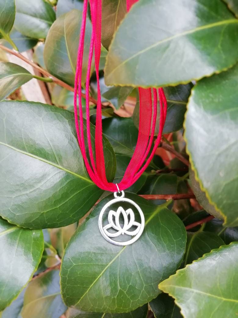 Lotus flower symbol necklace.