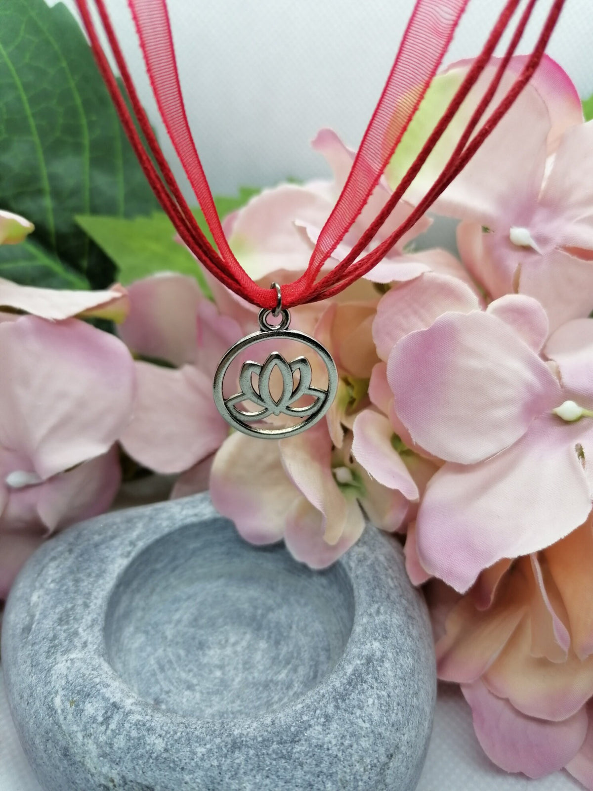 Lotus flower symbol necklace.