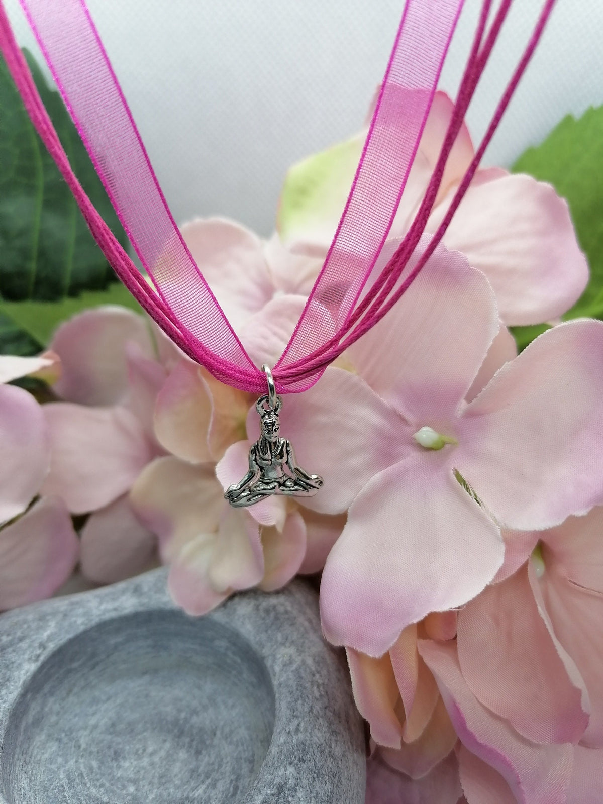 Buddha symbol necklace.