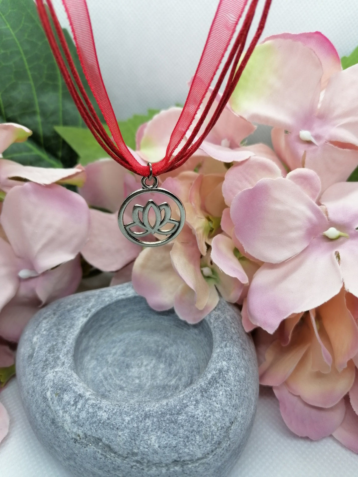 Lotus flower symbol necklace.