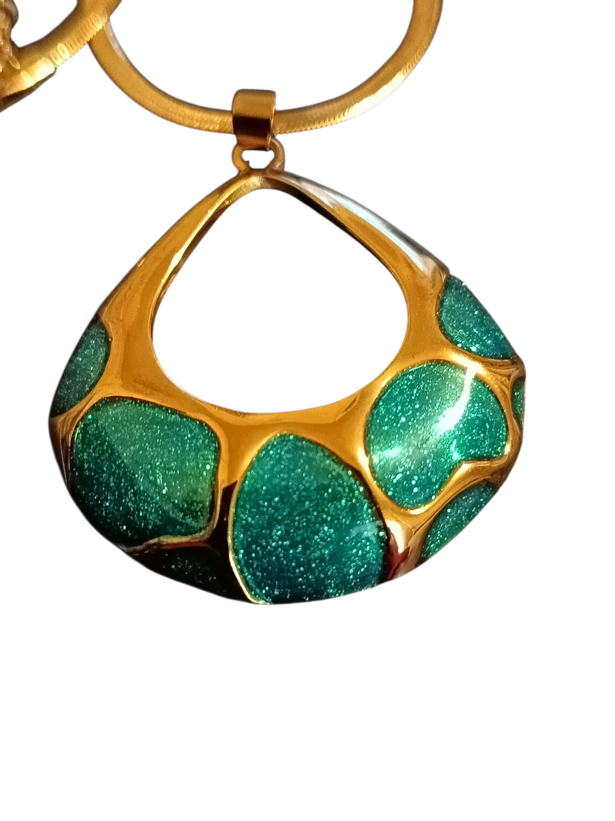 Close-up of teal blue glitter enamel teardrop pendant with gold electroplated frame