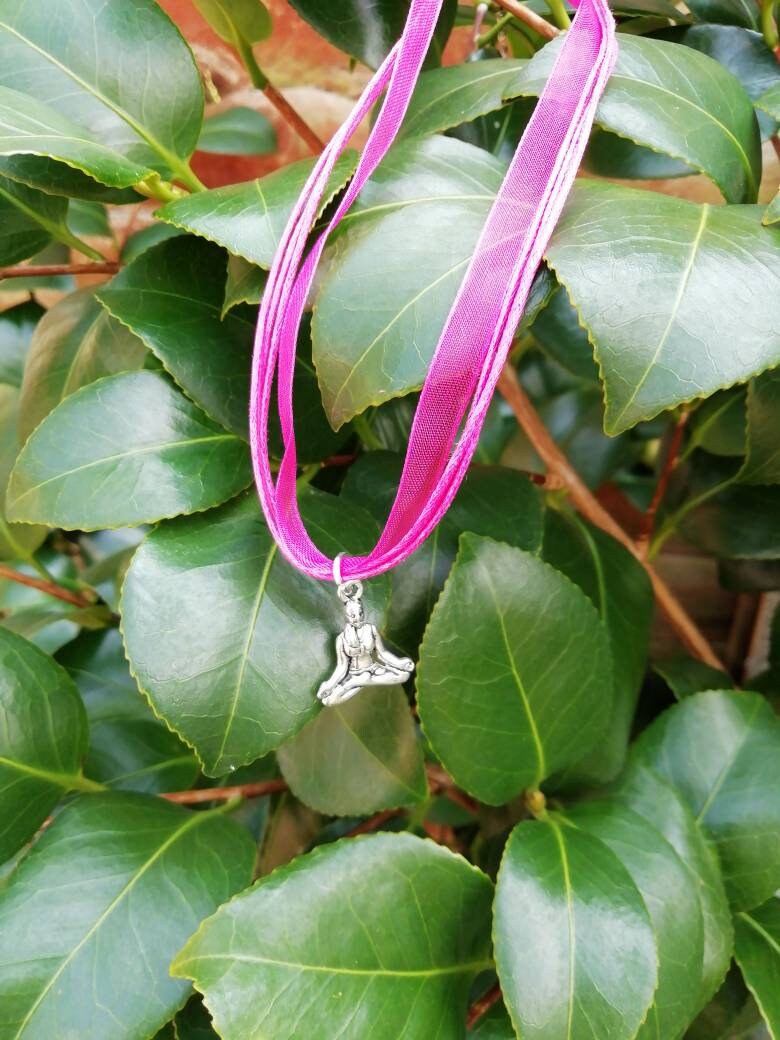 Buddha symbol necklace.
