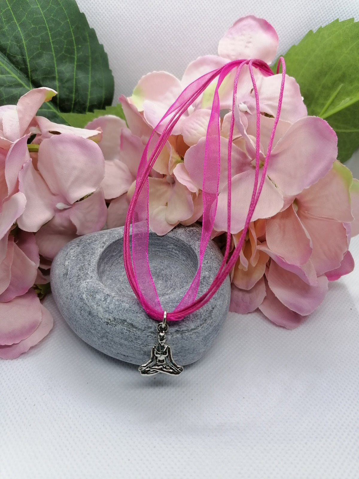 Buddha symbol necklace.