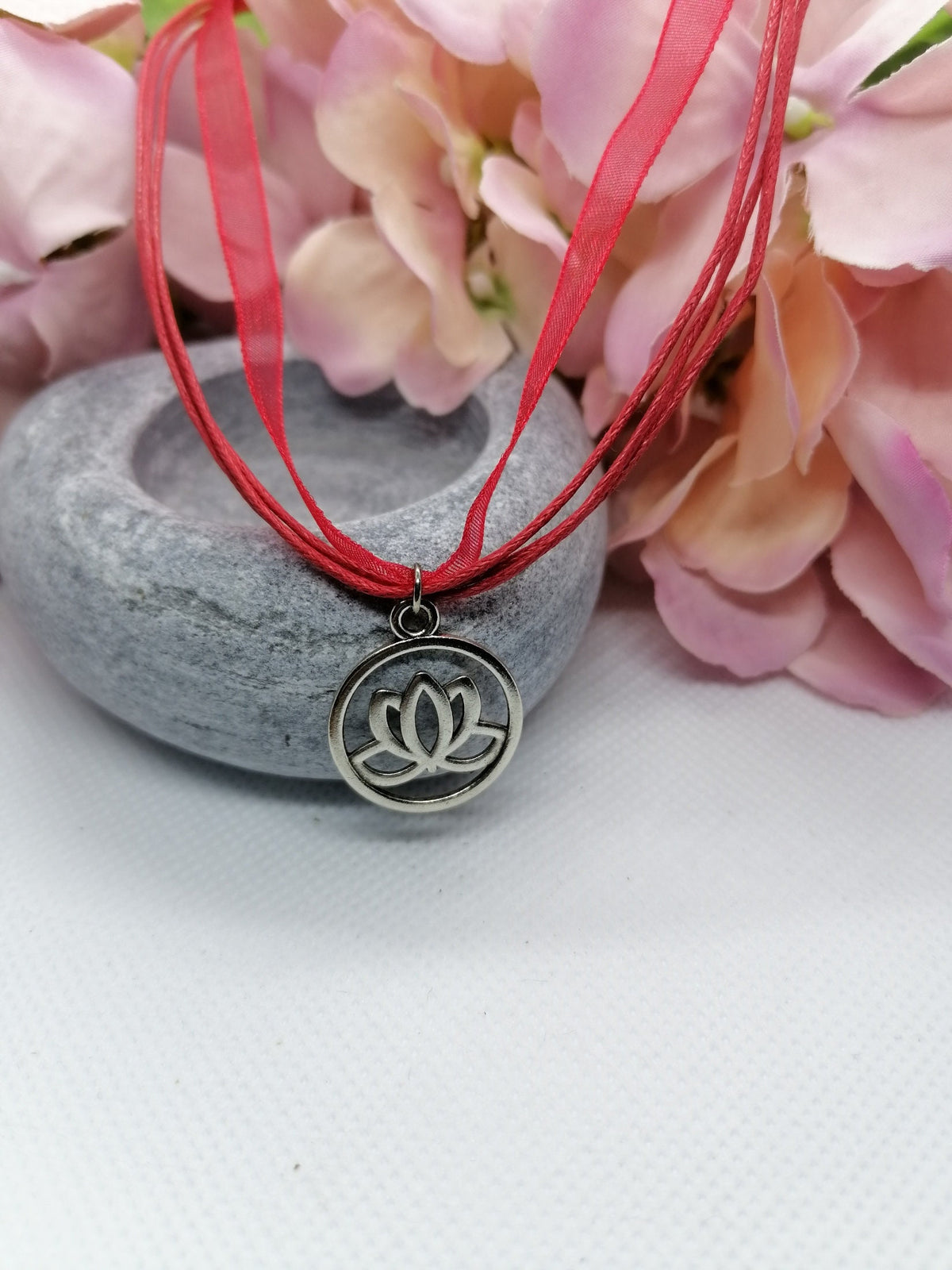 Lotus flower symbol necklace.