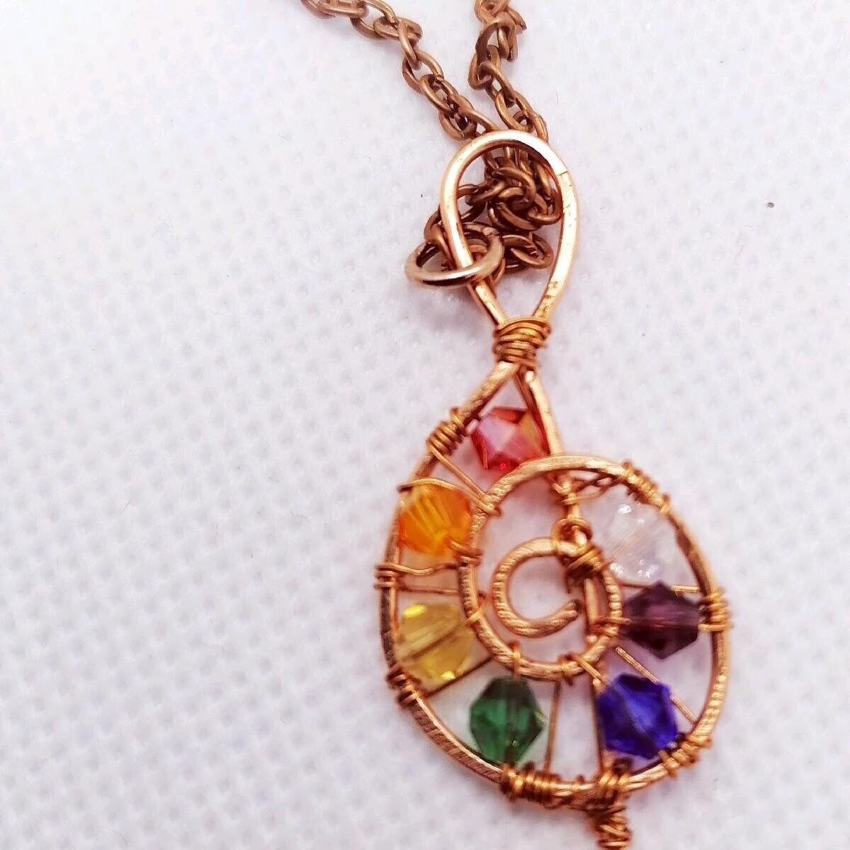 Copper wire wrapped treble clef beaded pendant